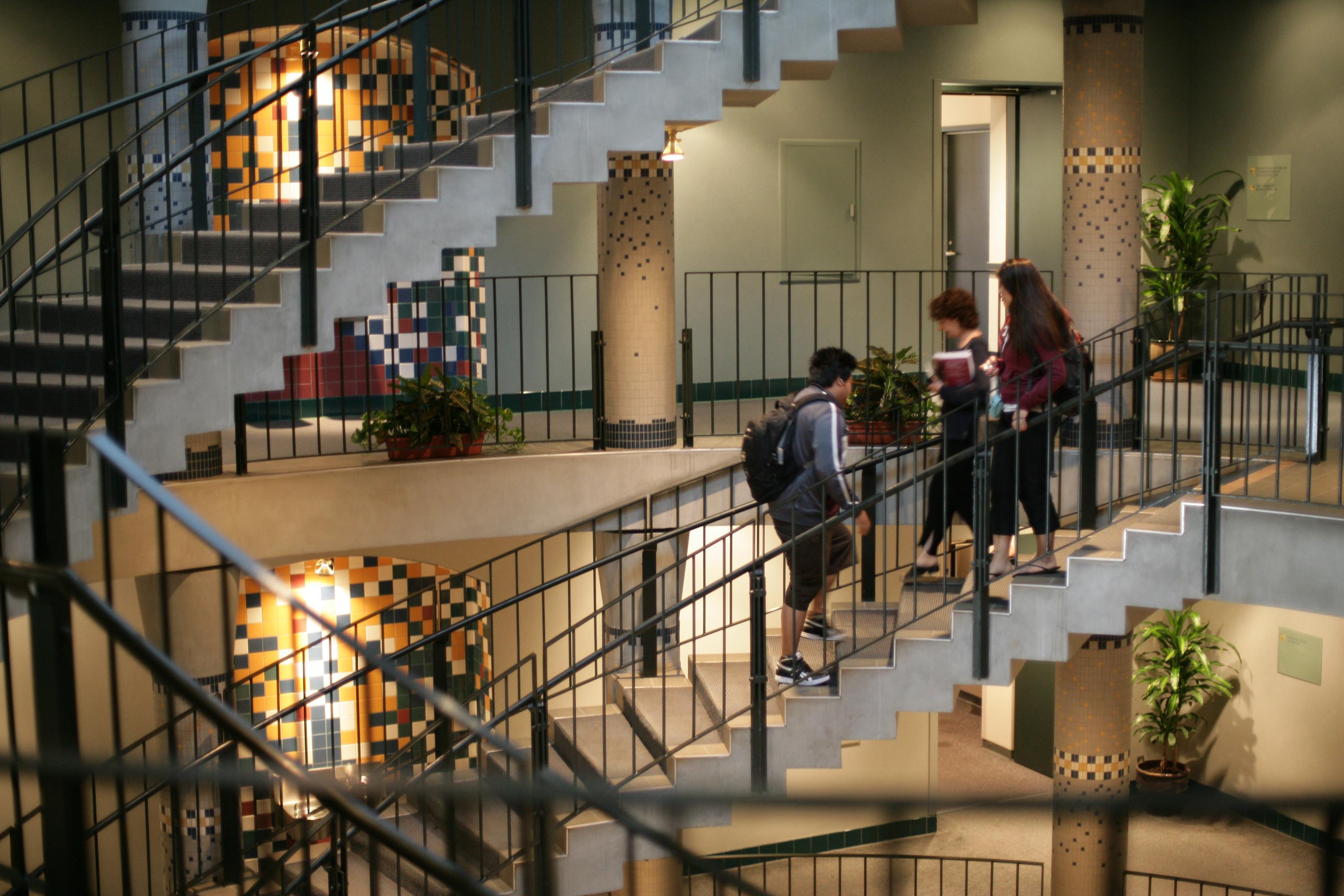 students walking in stairwell of UCLA Covel Commons