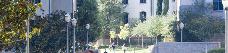 Students walking through a residence hall outdoor courtyard